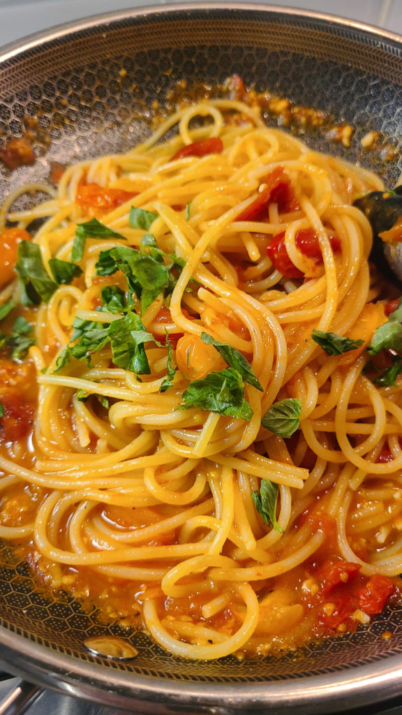 Spaghetti al Pomodoro topped with basil