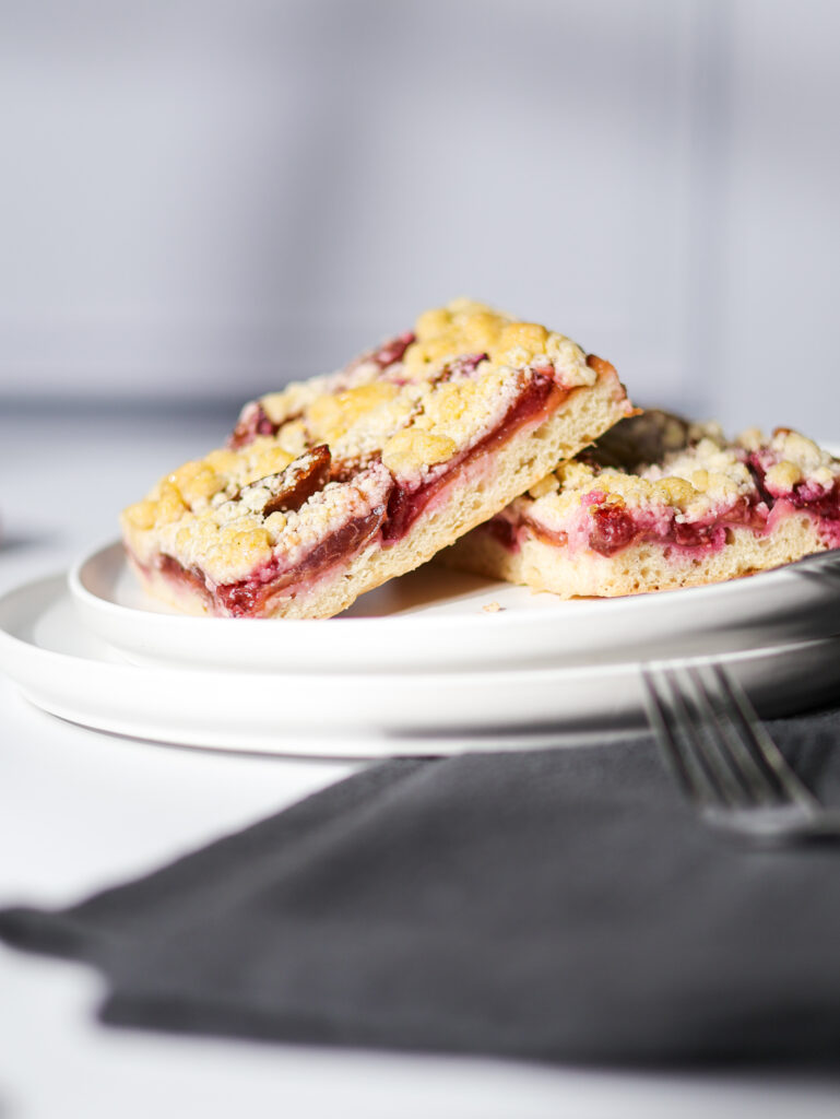 Two slices of German Plum Cake with Streusel (Zwetschgenkuchen) from a Girl and a Spoon